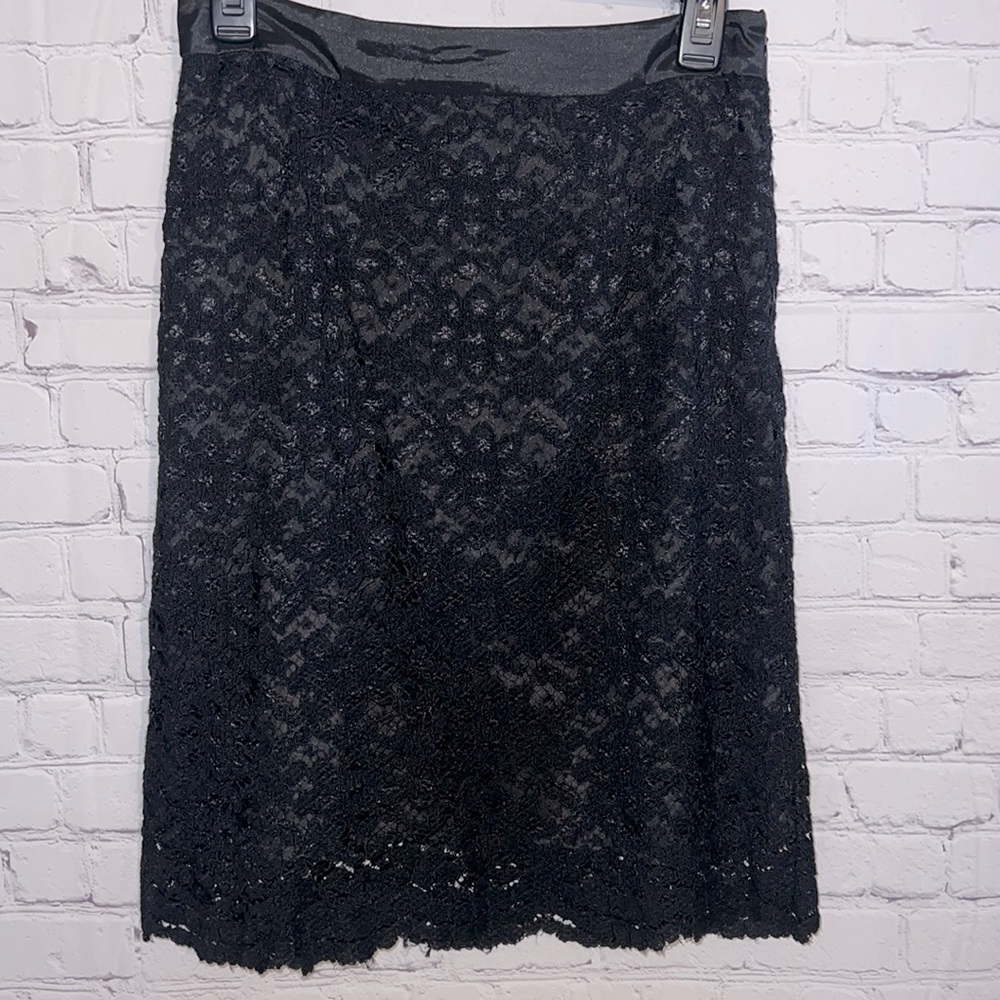Lined black lace straight skirt by Trulli. Satin waistband Side zipper
